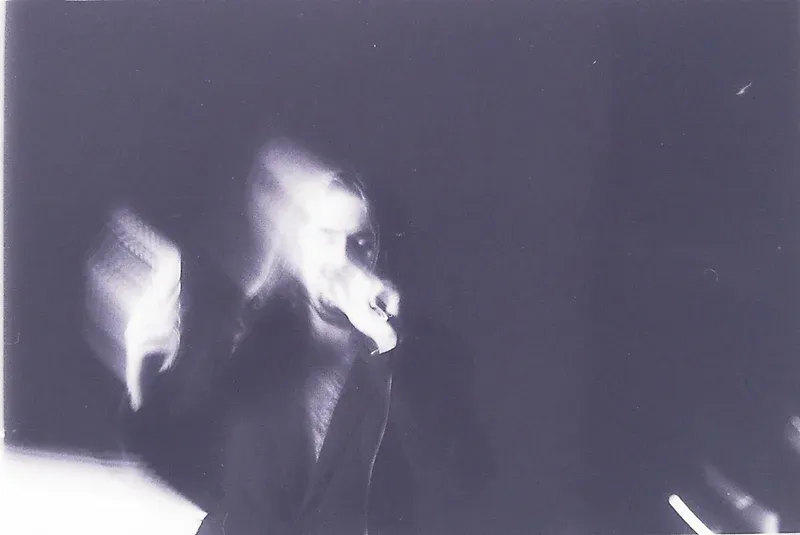 Two overlapping faces in a pale violet, high-contrast photograph